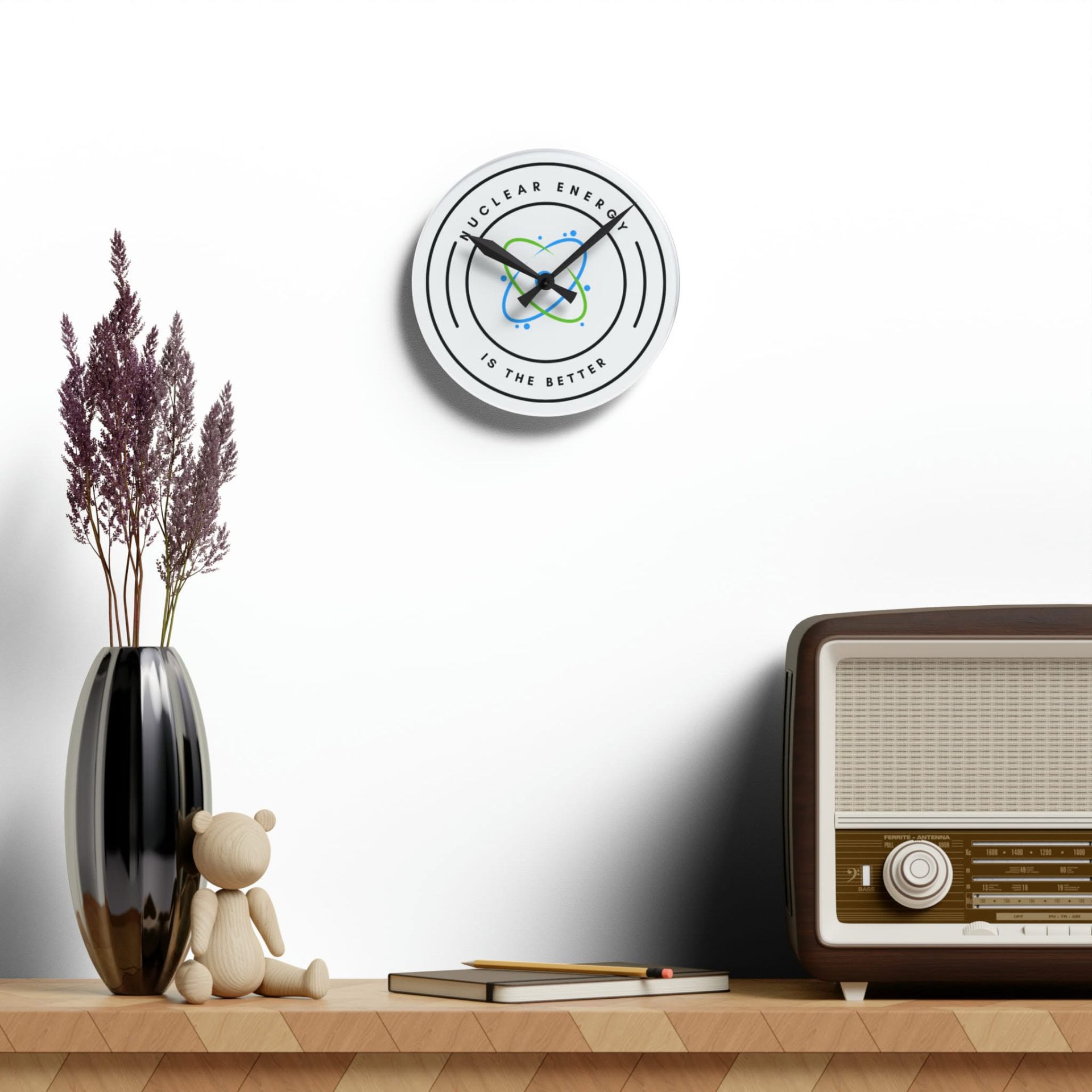 A Nuclear Energy is the Better wall clock hanging above a sideboard with a vintage radio